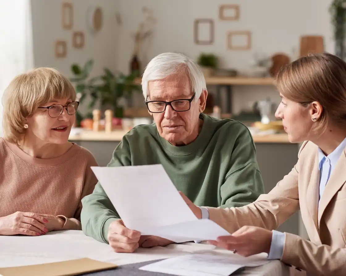 Older couple reviewing estate-planning documents with an adviser