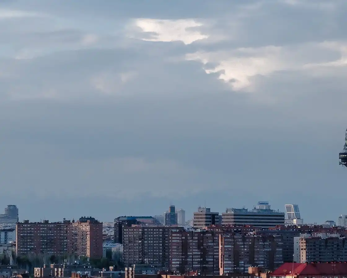 Madrid skyline beneath a broad pale sky